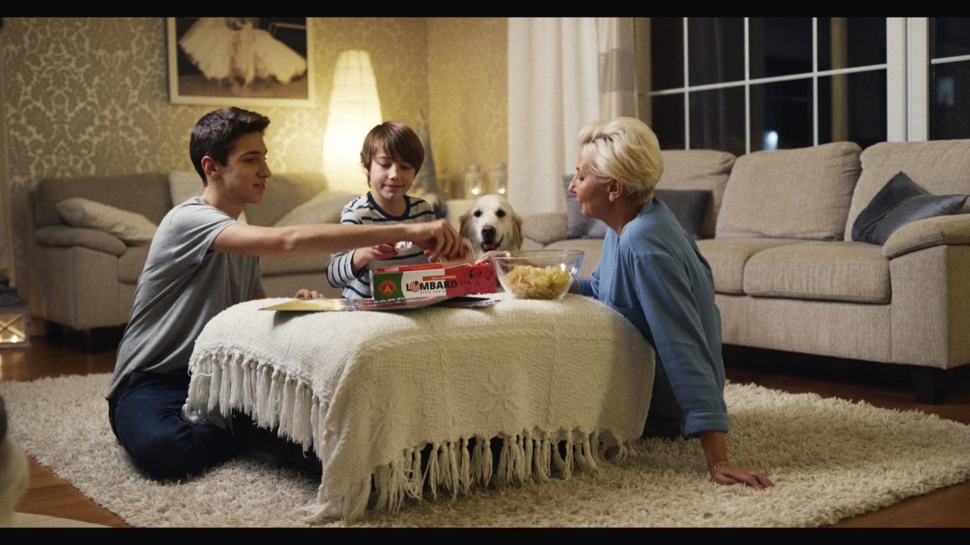 The family living room rendered through Kodak Vision3 5207 250D and Kodak Vision 2383.